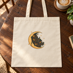 Moonlit Library tote print and cotton canvas detail on café tabletop — digital mockup