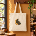 Moonlit Library cotton canvas tote hanging alone beside a café window — digital mockup