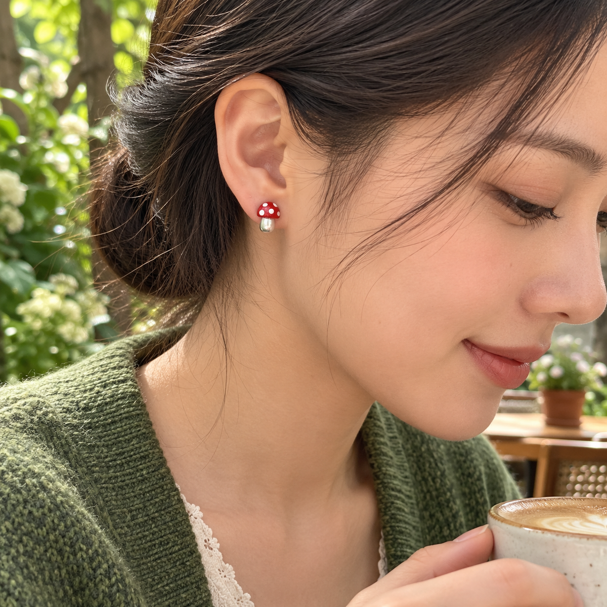 Small red mushroom stud worn at the earlobe in a garden cafe