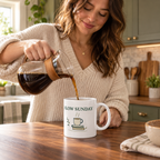 Slow Sunday Ceramic Mug — 11oz — person use: standing kitchen coffee pour; digitally styled supplier-based mockup